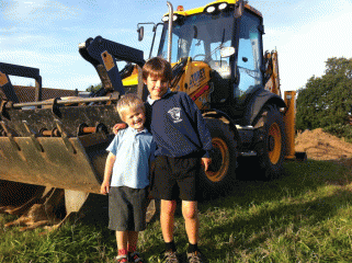 Tristan and Michael with a digger at the Wood View development, North Walsham